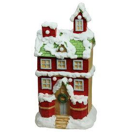 21.25" Red and White Snow-covered Two-Story House Pre-Lit LED Musical Christmas Tabletop Decoration