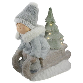 15" Beige and Green Lighted Boy on a Sled Christmas Decoration